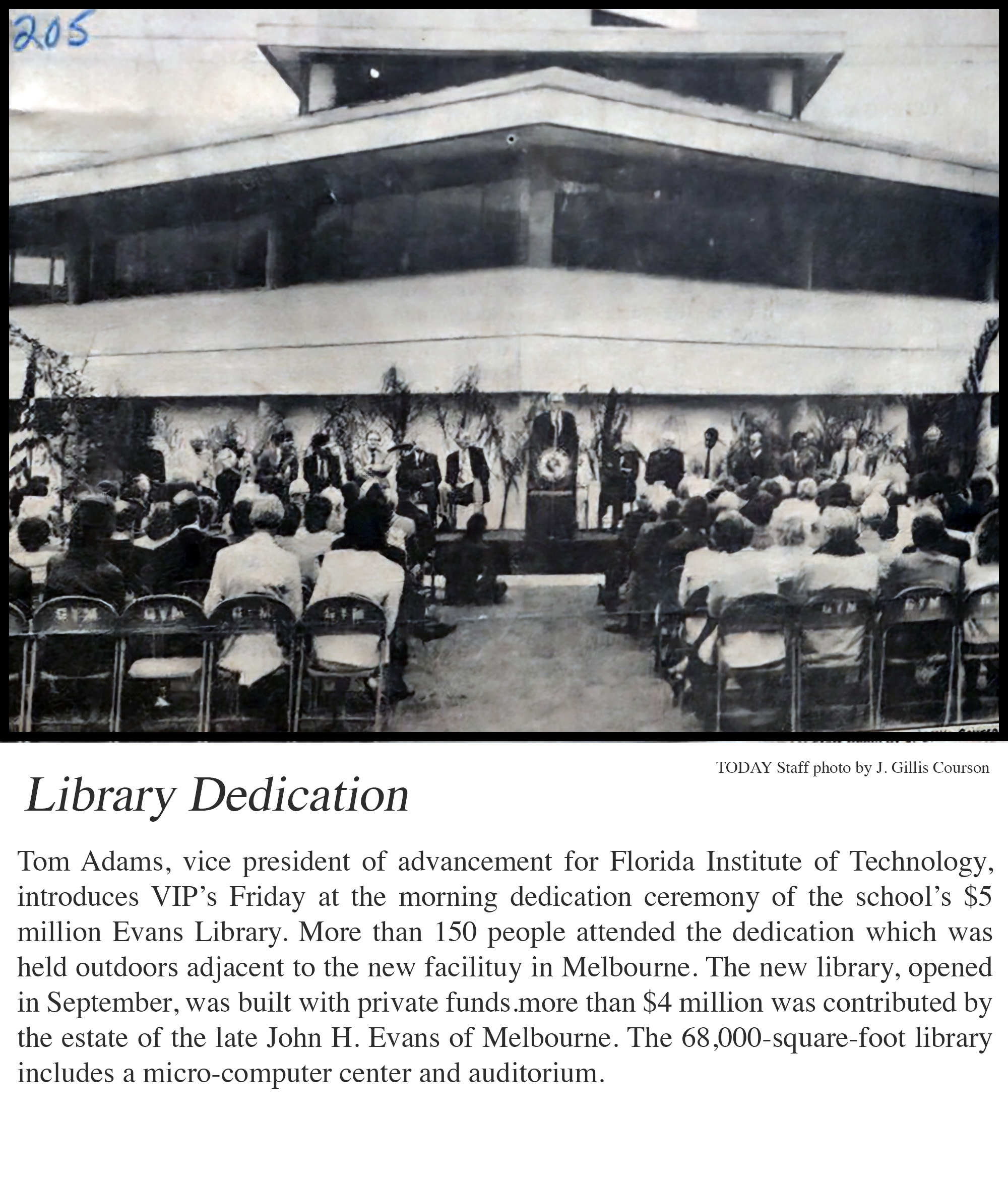 Library Dedication: A man (Tom Adams, VP of advancement at the time) at a podium with the Florida Tech seal on it stands on a stage in front of the library flanked by university executives in chairs, being observed by a small audience.